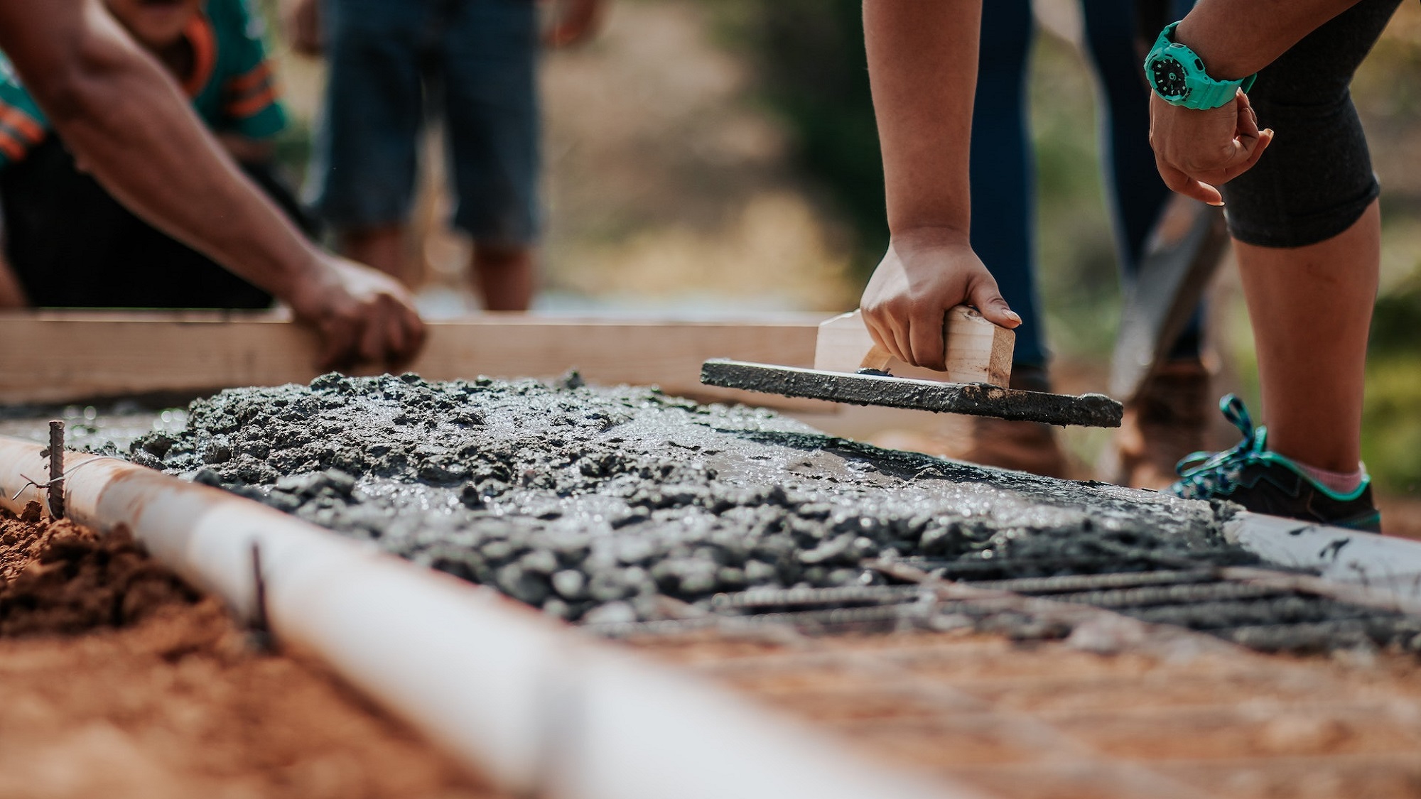 Couple sitting together on couch looking at laptop